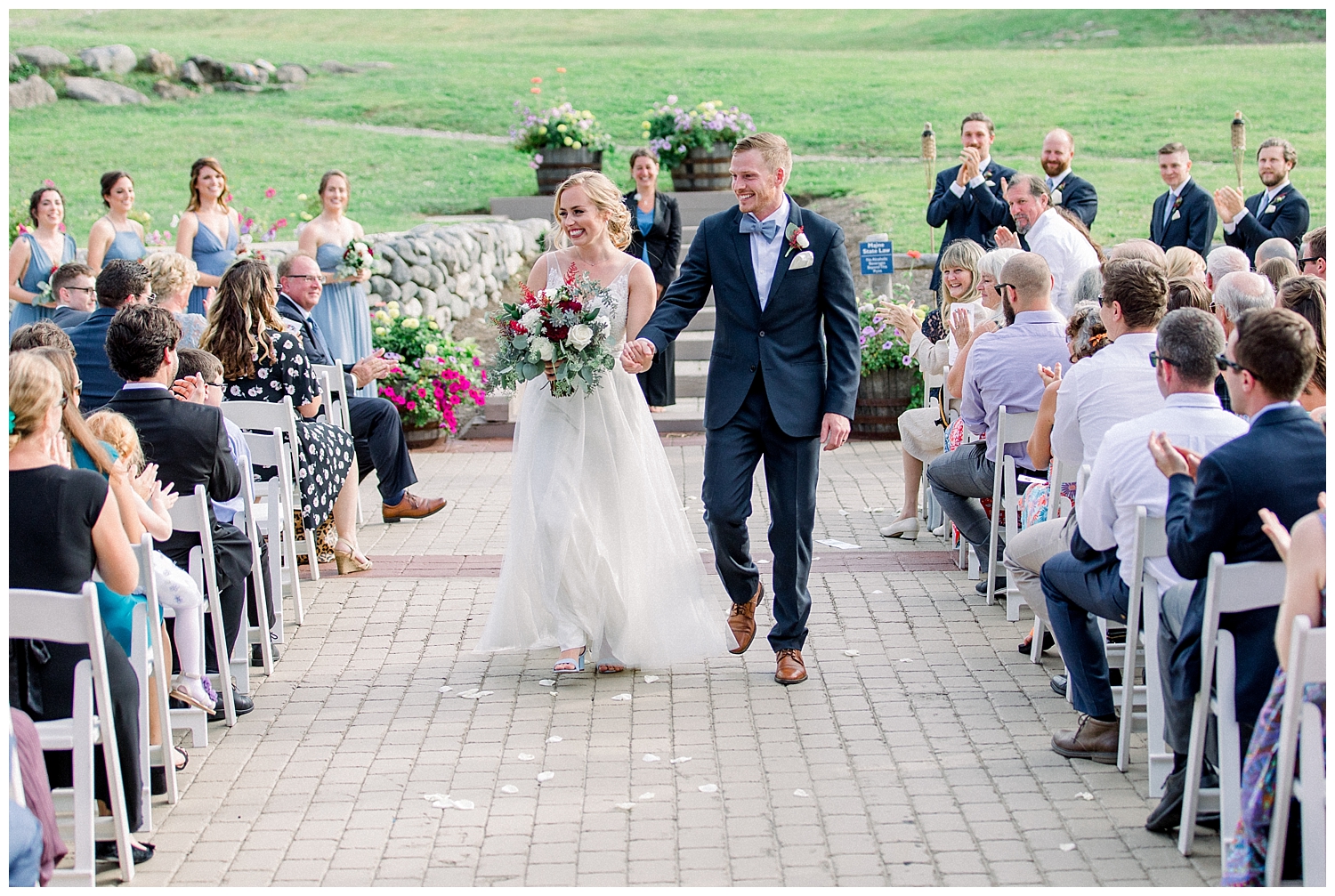 Bride and grrom coming down the aisle as husband and wife! Outside wedding ceremony at Sugarloaf Mountain Resort in Maine, photos by Halie Olszowy.