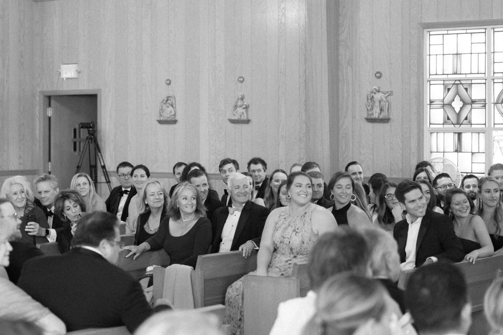 Wedding guest faces as the bride walks down the aisle