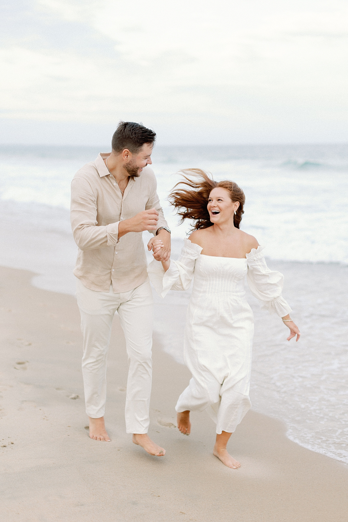 Couple running on East Beach in Watch Hill