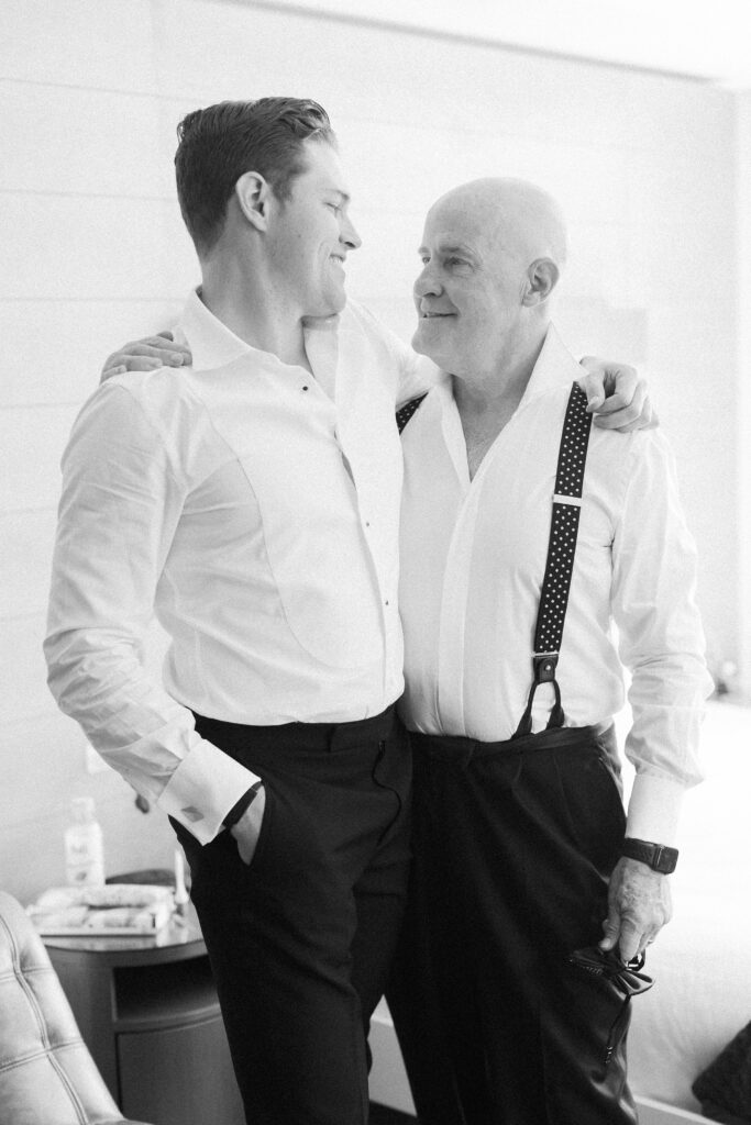 Groom and father getting ready for Boston wedding candid photo
