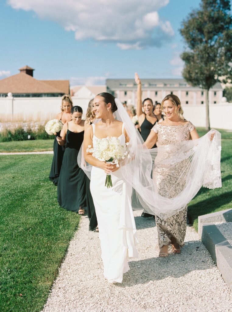 Bride and bridesmaids walking together before Newport wedding