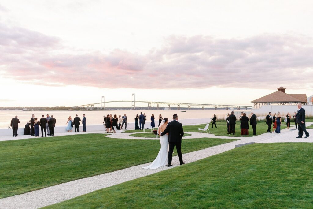 Bride and groom walking into cocktail hour at Belle Mer