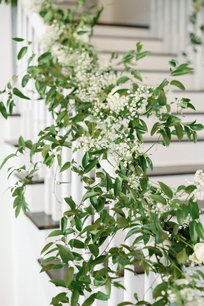 Ivy and baby's breath decorated stairs at Belle Mer wedding reception