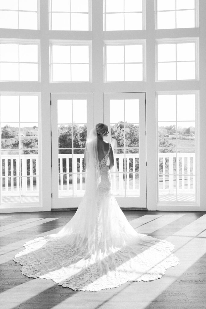 Black and white bride portrait with long lace train