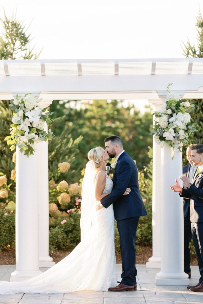 Bride and groom first kiss at Plymouth, MA Golf Club Wedding