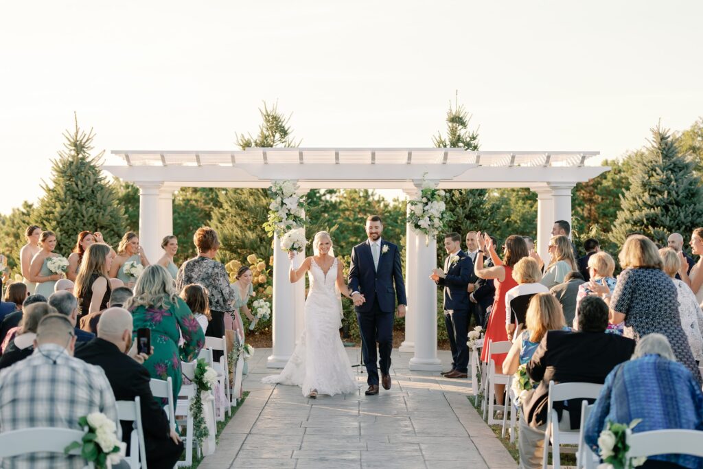 Bride and groom walking down the aisle as husband and wife
