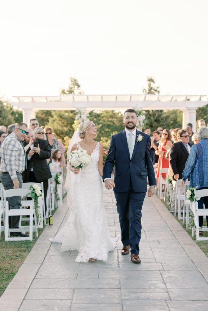 Bride and groom walking down the aisle as husband and wife at Waverly Oaks Golf Club
