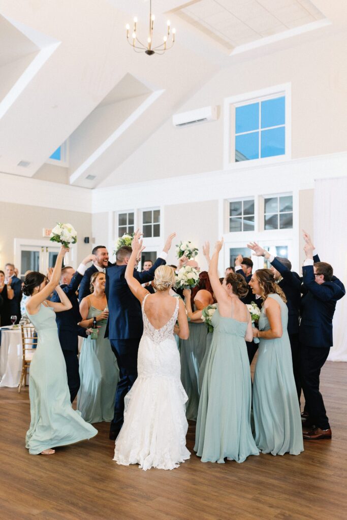 Bride and groom wedding entrance with bridal party