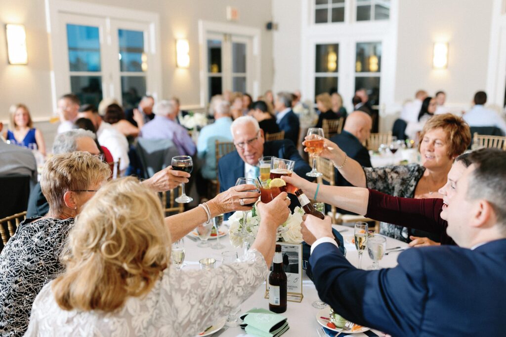 Wedding guests cheers at reception
