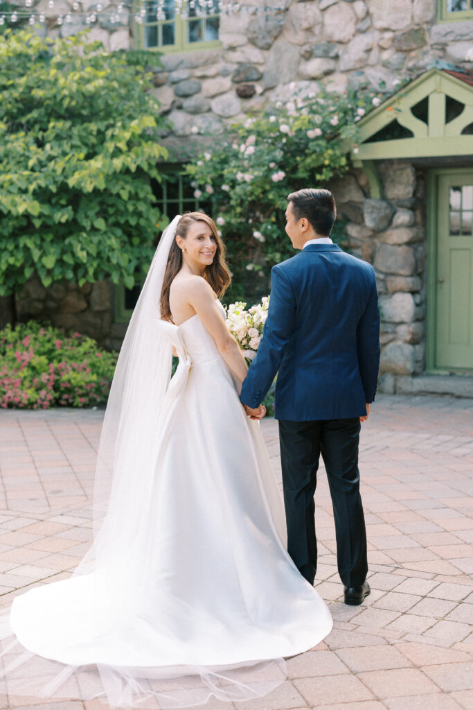 Bride and groom portrait in front of entrance at Willowdale Estate