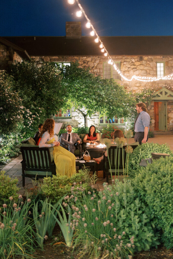 Guests relaxing by fire in Willowdale Estate courtyard