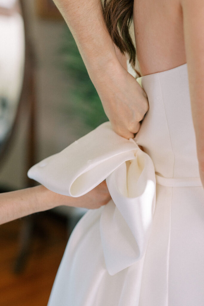 Close up bridal getting ready portrait of dress and bow