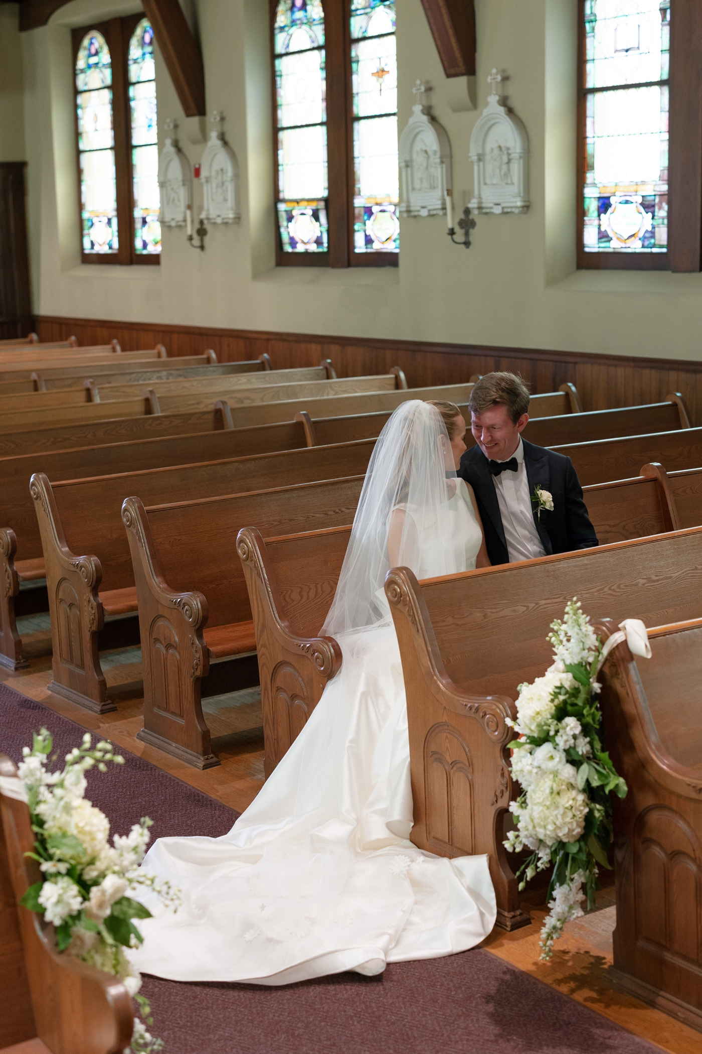 Bride and groom sitting in a church pew