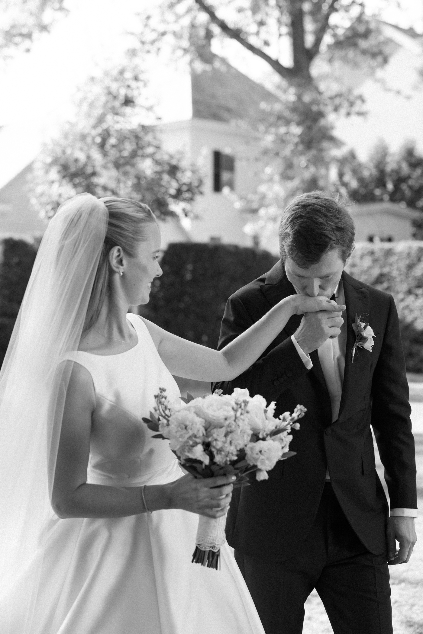 Groom kissing his bride's hand