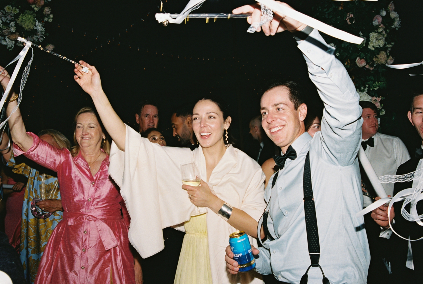 Guests waving streamers at a wedding reception