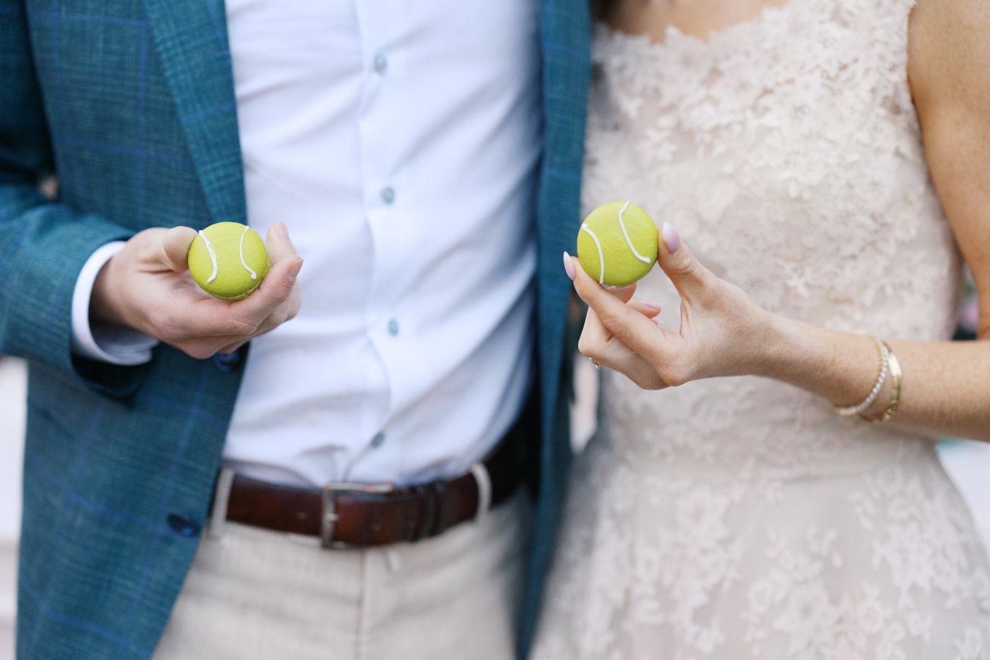 Couple holding tennis ball macarons