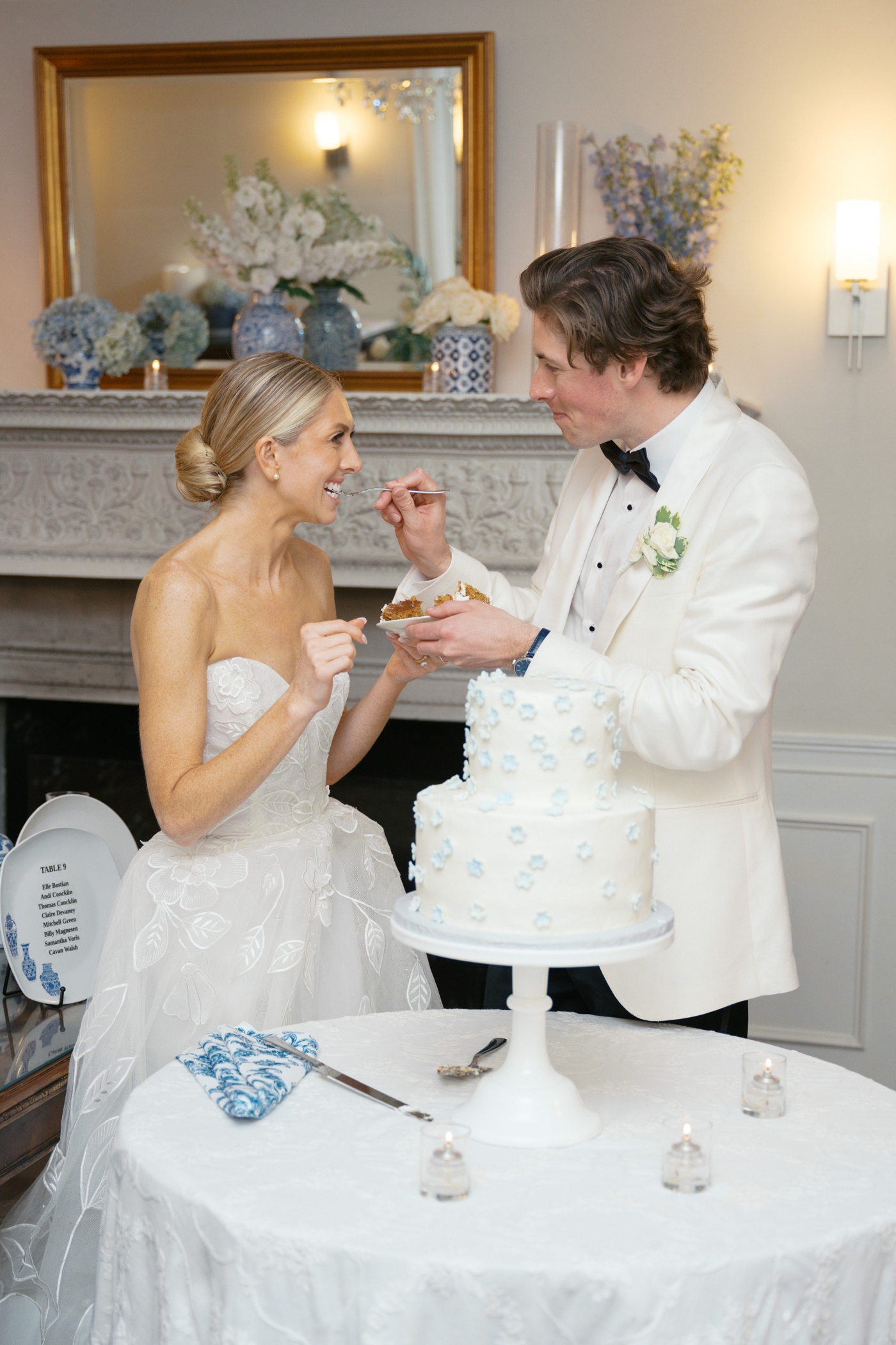 Groom giving bride a bite of wedding cake