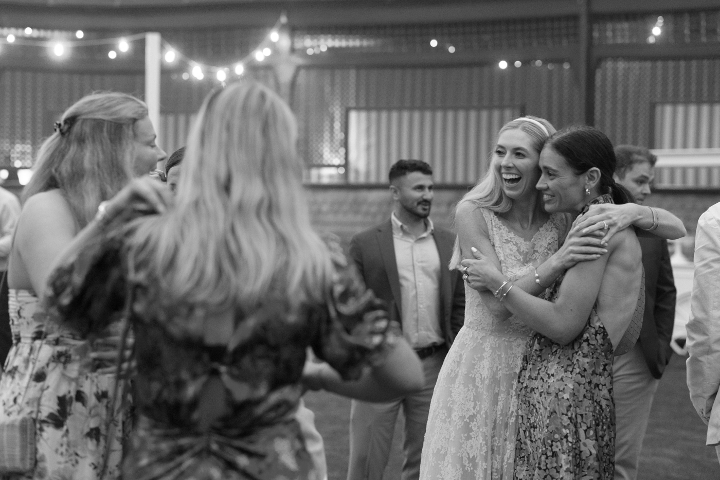 Bride hugging one of her guests at her wedding welcome party