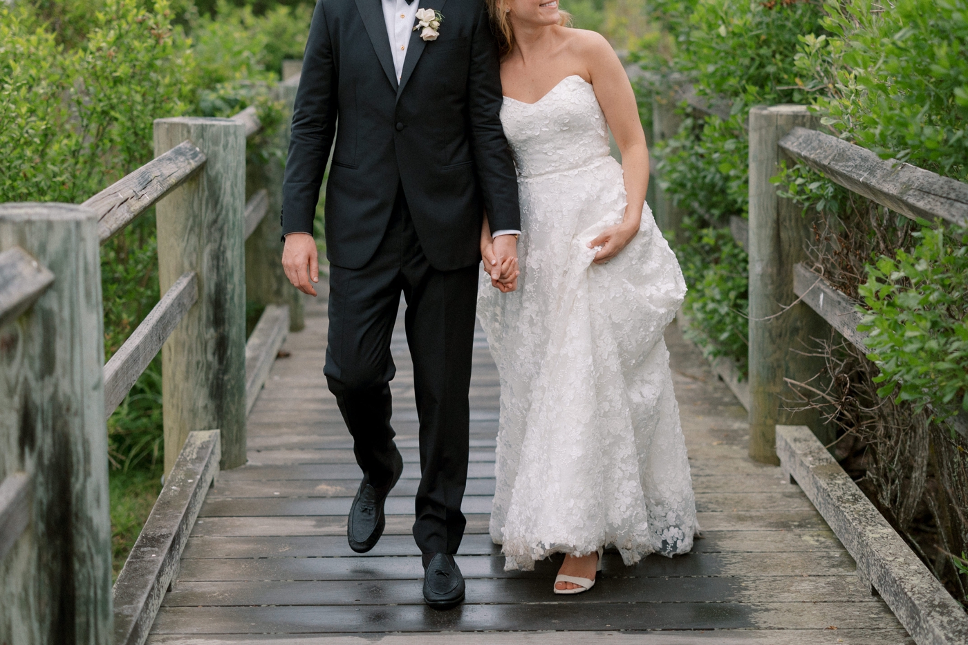 Bride and groom walking on dock